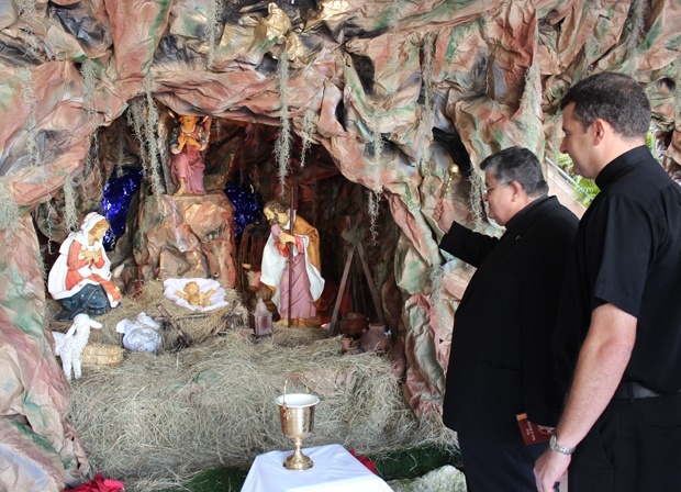 Jesuit Fathers Pedro Suarez and Jorge Rojas bless the nativity scene at Belen Jesuit Preparatory School.