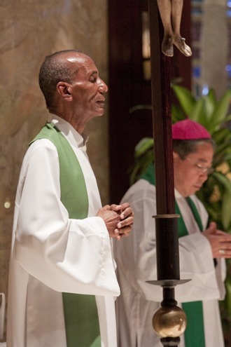 Bishop Pierre Antoine Paulo, vice-president of the Haitian bishops conference and bishop of Miami's sister diocese, Port-de-Paix, prays during the Mass alongside Archbishop Bernardito Auza, papal nuncio to Haiti.