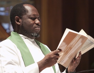 Father Hans Alexandre, permanent secretary of the Haitian bishops' conference, proclaims the Gospel during the Mass.