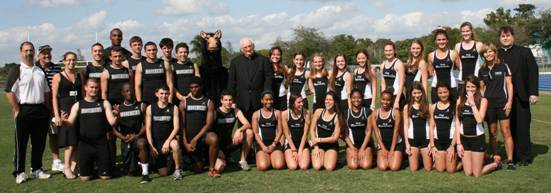 The Maverick Mens and Womens Track Team pose for a picture with Mascot Maverick, Father Brendan Dalton, supervising principal, center, head track coach David DiNicola, far left, and womens track coach Terri Swanson, far right.