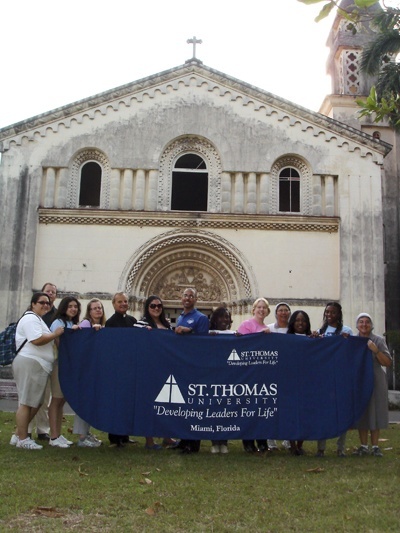 Students from St. Thomas University, joined by Msgr. Franklyn Casale, the school's president, pose for a picture in front of the chapel and the courtyard of Santo Tomas de Villanueva University in Havana, whose takeover by Fidel Castro's government resulted in the opening of the university here in Miami.