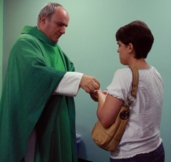 Father Roberto Cid distributes Communion during the Mass.