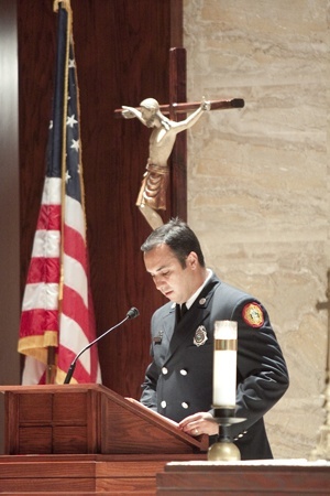 A Miami-Dade County firefighter from Station 30 in Miami Shores reads the first reading.