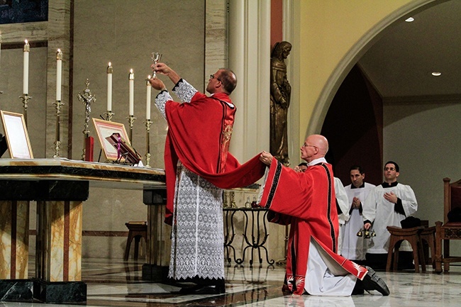 Father Chris Marino consecrates the Eucharist during the Mass.