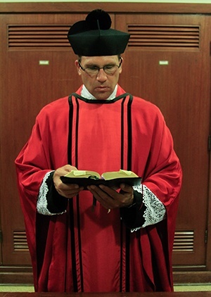 Father Chris Marino prepares before the start of the Mass.