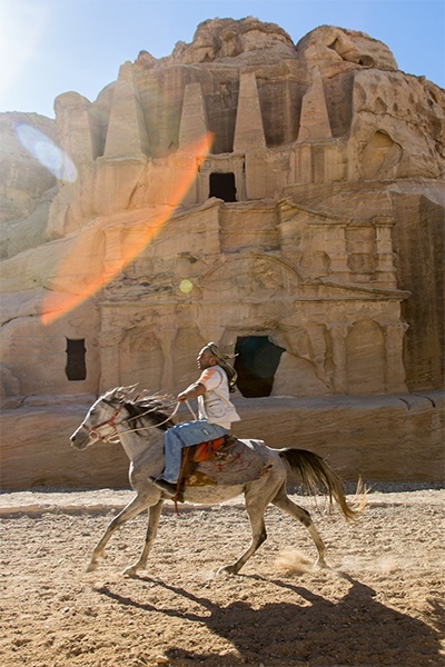 At Jordans Petra, a Bedouin man races past visitors at the well-preserved and once lost ancient city built by Nabataean traders and conceivably a location where the three wise men of the New Testament may have stopped to purchase their gifts. Horses, camels and donkeys are a popular way to explore Petra.