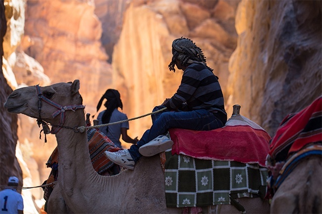 Bedouin guides patrol the entrance and narrow alleyways through Jordans Petra, the ancient city built by Nabataean traders and conceivably a location where the three wise men of the New Testament may have stopped to purchase their gifts.