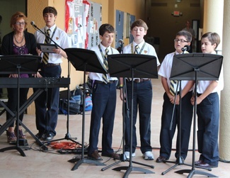 Members of the sixth grade choir led students in singing Christmas carols throughout the blessing ceremony.