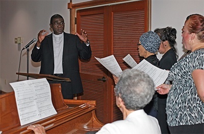Father Jude sings, "Nuriba-Onu" (Rejoice in the Lord), a Christmas carol in his native Igbo, along with the St. Martha choir.