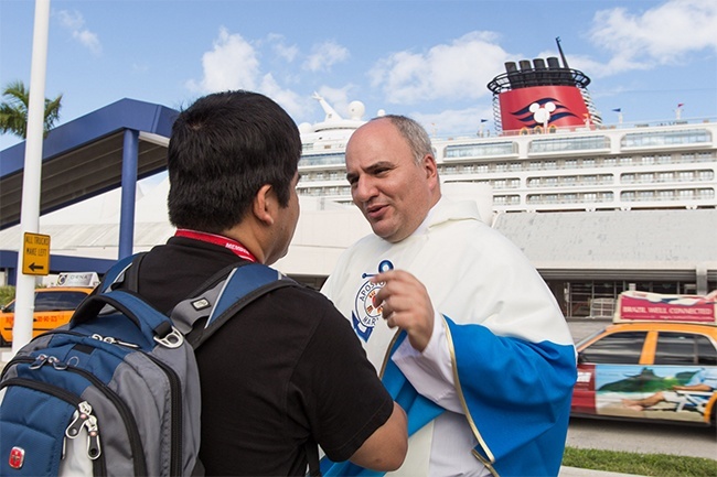 Father Roberto Cid, St. Patrick's pastor and newly-appointed director of the Stella Maris center, chats with a crewman from a Disney cruise ship who stopped by on the morning of the center's "soft opening."