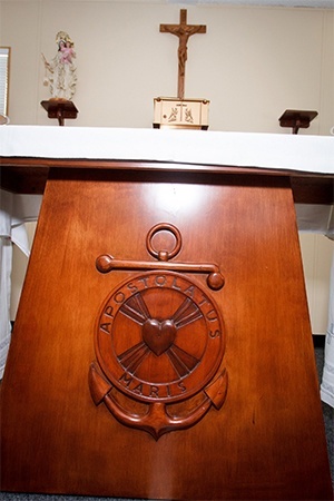 The chapel of the Stella Maris Catholic Center at the Port of Miami has a wooden altar bearing a mariners emblem and reading Apostolatus Maris that was hand-made by a local craftsman.