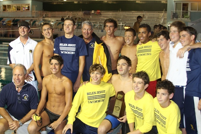 Belen Jesuit swimmers and coaches celebrate their win after the regional championship. Their next competition is to defend their state title.