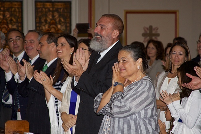 Family and friends stand to cheer for Jesuit Father Emilio Travieso at the conclusion of the Rite of Ordination. Center,  his father, Raimundo, and mother Maria Isabel Morayda Travieso, smile with pride at their son.