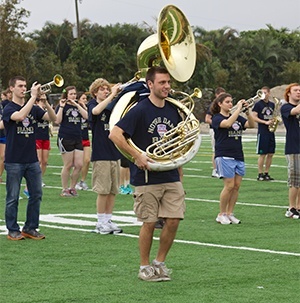 The Notre Dame marching band's "horn section" practice their routine on the football field at Cardinal Gibbons High School.