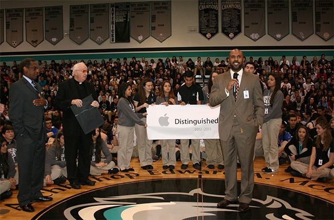 Richard Jean, principal at Archbishop Edward McCarthy High School, speaks after the school was presented the Distinguished School award by Apple for its one-to-one iPad program, the first in the archdiocese. At left is Donald Edwards, associate superintendent of schools for the archdiocese, and Father Brendan Dalton, president and supervising principal of McCarthy High.