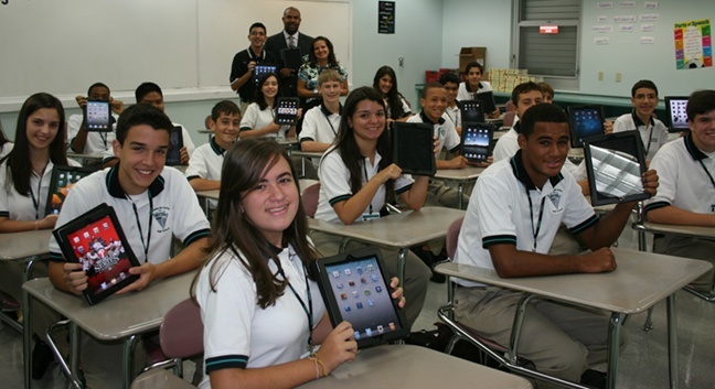 Students at Archbishop Edward McCarthy High School showed off their iPads when they first received them, in August 2011. The school was the first in the archdiocese to give one out to every student.