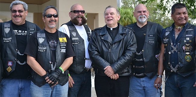 Archbishop Thomas Wenski poses with those who served as road captains for the poker run, including, second from right, Rene John Sardina, president of the Miami chapter of the Chrome Knights Motorcycle Association.