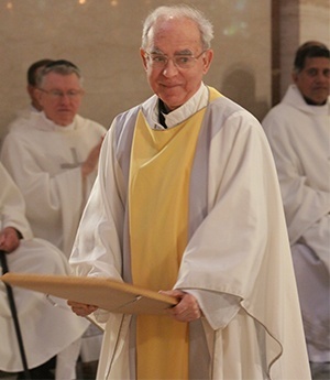 Father George Cardona steps away after being congratulated by the archbishop on his 60th anniversary in the priesthood.