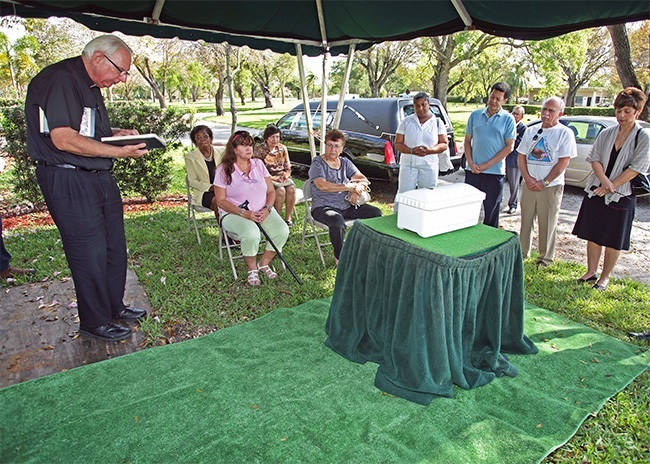 Father David Smith, Catholic Hospice chaplain, leads the graveside ceremony in the Garden of Innocence at Caballero Rivero Woodlawn Cemetery for a baby girl abandoned in Clearwater.