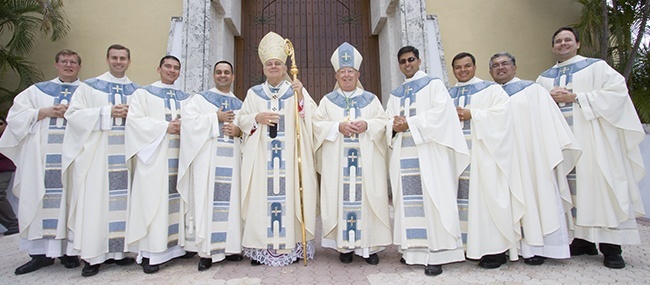 The newly ordained pose with the archbishops and seminary rectors after the ceremony, from left: Father Emanuele De Nigris, rector of Redemptoris Mater, the Neocatechumenal seminary; Msgr. David Toups, rector of St. Vincent de Paul Regional Seminary, Boynton Beach; Father Fredy Yara; Father Carlos Cabrera; Archbishop Thomas Wenski; Archbishop Emeritus John C. Favalora; Father Daniel Martin; Father Elvis Gonzalez; Msgr. Roberto Garza, rector of St. John Vianney College Seminary in Miami; and Father David Zirilli, archdiocesan vocations director.