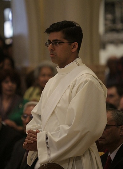 Deacon Daniel Martin stands up after being presented to the archbishop.