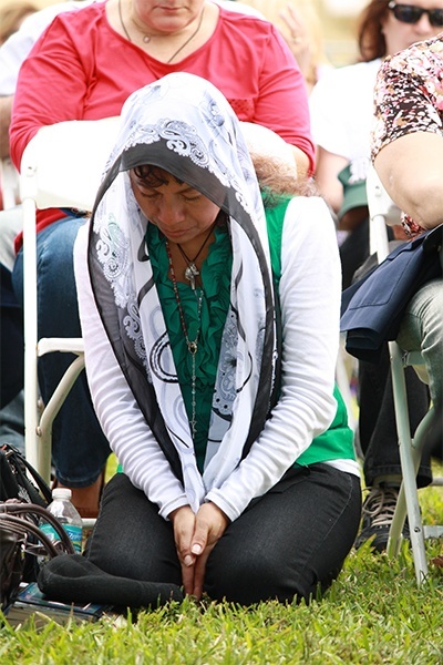 Divine Mercy devotee, Amelia Hernandez, prays during Eucharistic adoration.