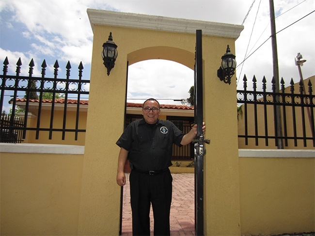 Deacon Edgardo Faras opens the door to the new St. Dismas center on the grounds of St. Robert Bellarmine Mission in Miami, which will serve the needs of families of inmates in Miami-Dade County.