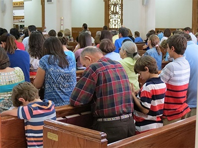 Families pray during the Mass, after Father Michael Davis gave his homily on the importance of having courage and faith in defending the rights of Catholics, especially at a time when Christian values are being threatened.