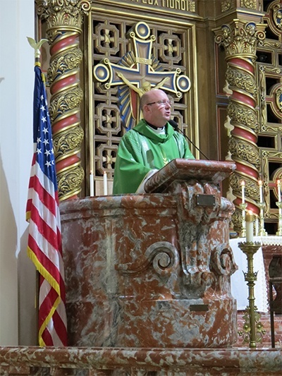 Father Michael Davis celebrates Mass at Little Flower Church to raise awareness about religious freedom and the upcoming HHS contraceptive mandate for employers who offer health benefits to their employees.