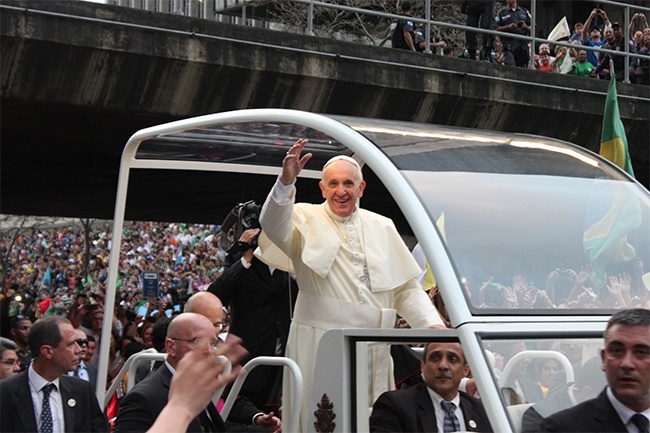 Pope Francis waves to the young people after arriving in Rio.