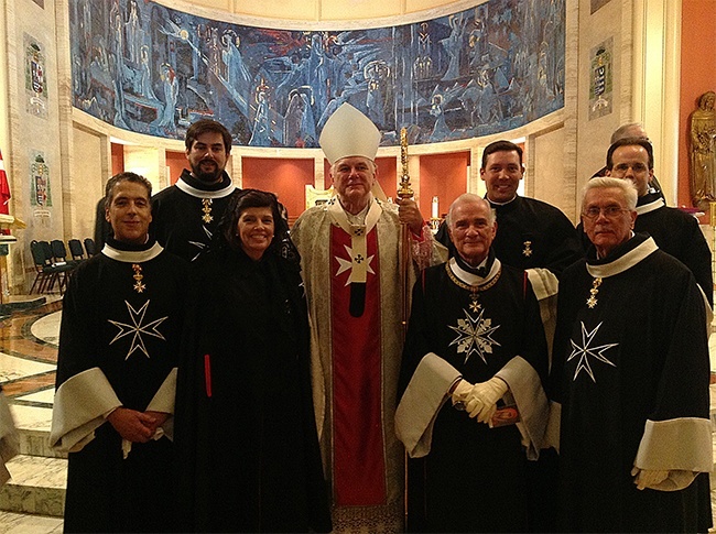 Newly invested members of the Cuban Association of the Order of Malta pose for a photo with Archbishop Thomas Wenski after the Investiture High Mass celebrated at St. Mary Cathedral in June. The new members are: Knights Luis Perez, Felix Caceres II, Jason Poblete, George Hillyer, Dame Maria Valentina Calvo, and Chaplain Father Richard Vigoa. Second from right, at front, is the association's president, Fernando Garcia Chacon.