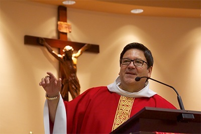 Mother of Our Redeemer's pastor, Father Jimmy Acevedo, addresses his congregation during a Mass celebrating the parish's 25th anniversary.