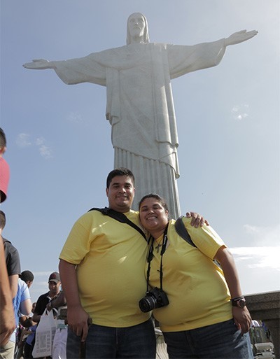 Ronald Rivas and Maria Rivas pose for a photo, elated, as they reached the Christ the Redeemer statue on the Corcovado.