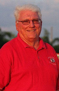 Paul Ott is seen here on the football field, wearing a Cardinal Gibbons polo shirt.