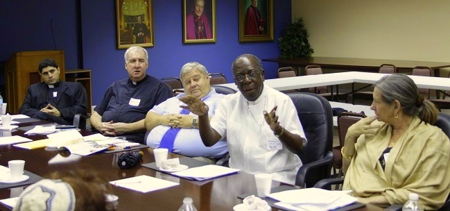 Dr. J. Fritz Bazin discusses race and social justice at MCCJ's monthly dialog.  From left to right: Father Elie Saade, Father Richard G. Mullen, Pastor David Imhoff, Dr. J. Fritz Bazin and the Rev. Audrey Bloom.