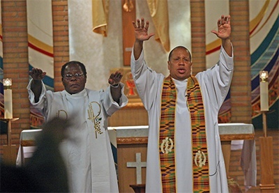 Father Bozeman and Father Alexander Ekechukwu, Holy Redeemer administrator, bless the congregation after the revival talk.