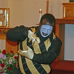 Glenn Jackson of Hands of Inspiration dances to "Break Every Chain" before the start of the revival talk at St. Philip Neri Church in Miami Gardens.