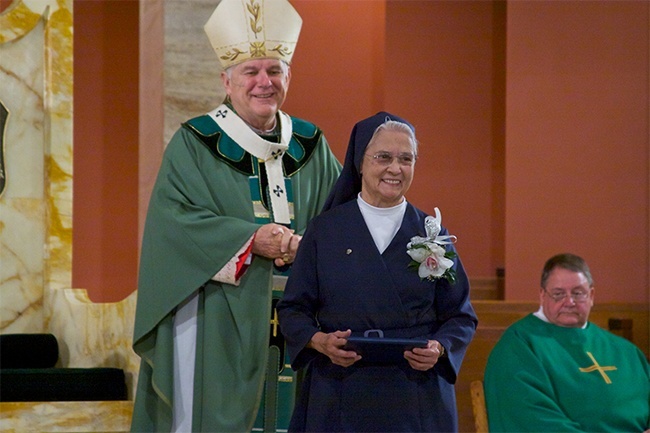 Sister Adela de la Cruz of the Daughters of Charity of St. Vincent de Paul receives a certificate of recognition for her diamond jubilee, 60 years of religious profession.