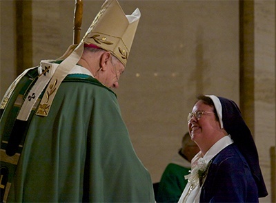 Sister Silvia Martinez of the Misioneras Corazn de Mara, currently a teacher at St. John the Apostle School in Hialeah, greets Archbishop Thomas Wenski and receives a certificate of recognition for her silver jubilee.