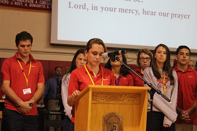 Cardinal Gibbons student Camille Chambliss prays for all victims of oppression during the school's Ash Wednesday prayer service.