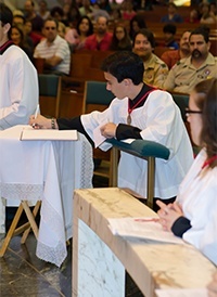 Server Donald Barraque signs the Book of Enrollment.