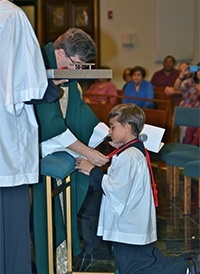 Server James Bassalo receives the Guild of St. Stephen.