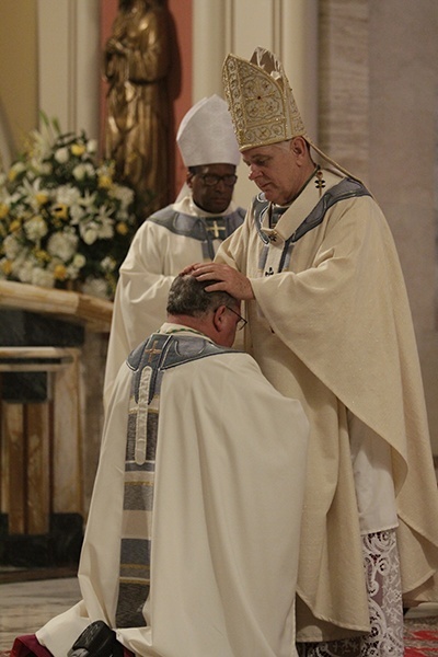 Archbishop Thomas Wenski lays hands on Msgr. Peter Baldacchino, calling down the Holy Spirit and ordaining him a bishop, successor to the apostles.