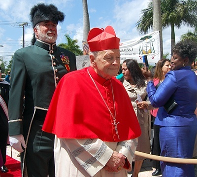 Cardinal Theodore McCarrick, who ordained Bishop Peter Baldacchino as a priest for the Newark archdiocese, enters the cathedral followed by a Knight of St. Gregory.