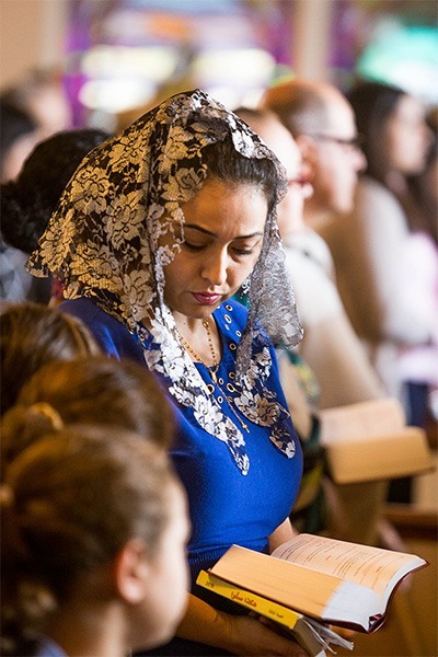 A mother and her children pray March 2 at Heart of Jesus Maronite Church in Fort Lauderdale.