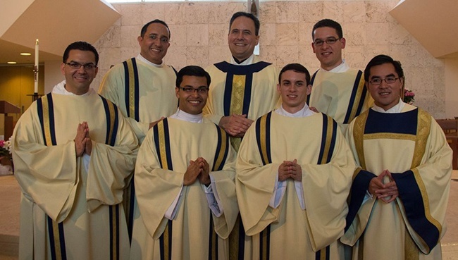 Pictured are six men from the Miami Archdiocese who were among a group of 13 Florida seminarians to be ordained to the transitional diaconate April 26. At top, from left, are Deacon Julio de Jesus, Father David Zirilli, archdiocesan vocations director, and Deacon Bryan Garcia. At bottom, from left, are Deacons Javier Barreto, Yamil Miranda, Michael Garcia and Phillip Tran. Bishop Gregory Parkes of Pensacola-Tallahassee, representing the bishops of Florida, celebrated the ordination Mass at St. Joan of Arc Church in Boca Raton. The deacons will spend the next year working in a parish on weekends while completing their theology studies at St. Vincent de Paul Seminary in Boynton Beach. In addition to the six from Miami, four were ordained for the Diocese of St. Petersburg, two were ordained for Orlando, and one was ordained for St. Augustine.