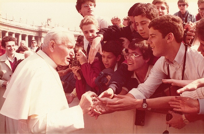 A teenaged Rafael Capo, first from right, greets Pope John Paul II after sneaking into the front of St. Peter's Square at the first World Youth Day.