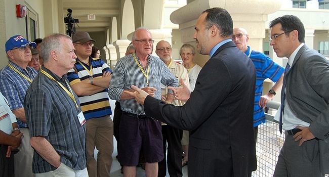 Visitors to Camillus House listen to Eduardo Gloria, vice president of strategy, during a tour of the eight-story facility.