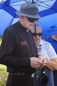 Father Dominick O'Dwyer, pastor of St. Malachy Church in Tamarac,  leads the rosary during a ceremony commemorating the National Day of Remembrance for aborted children.