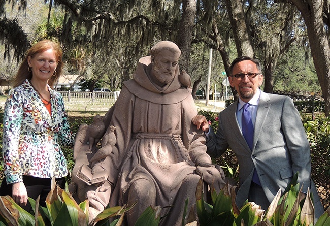 Eileen Coogan Boyle, president and CEO of Allegany Franciscan Ministries, and Miguel Milanes, Miami-Dade regional vice president for the foundation, pose here with the statue of St. Francis that used to grace the entrance of St. Francis Hospital in Miami Beach. When the hospital was sold, it was brought to the Franciscan Center in Tampa, where this picture was taken.